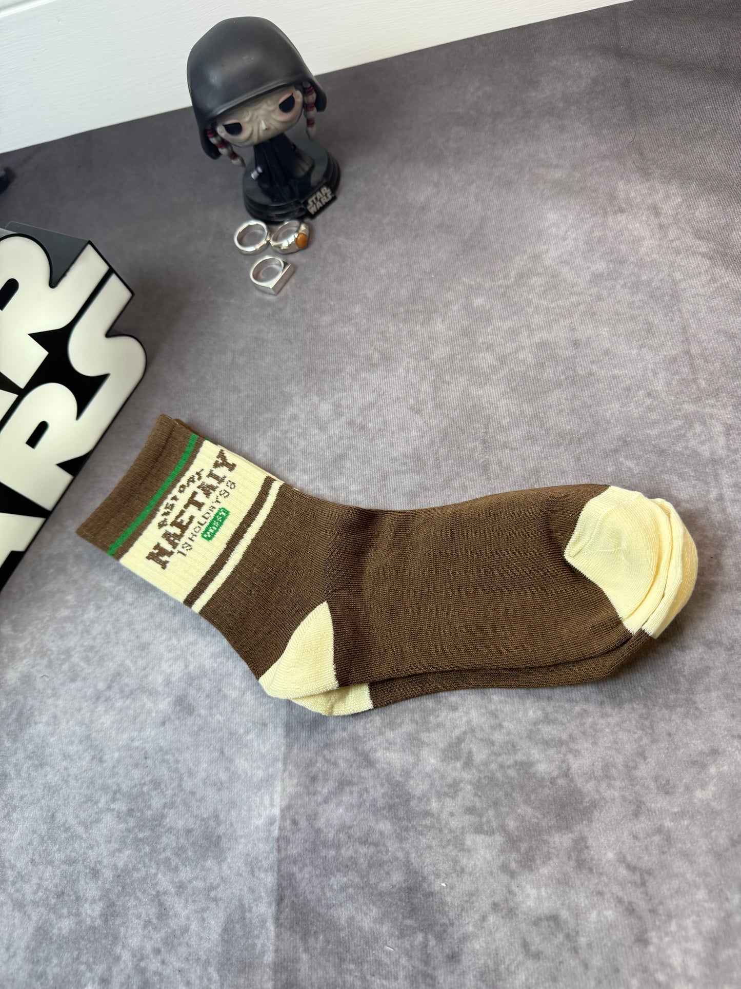 Socks With Letter And Geometric Patterns In Dark Brown Color.